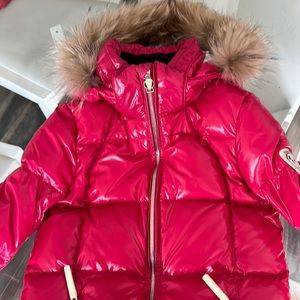 A beautiful ladies pink ski jacket with real fur